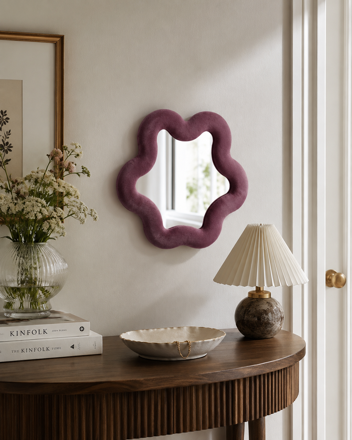 Miroir Alma prune en velours installé au mur au-dessus d’une console dans un intérieur chaleureux